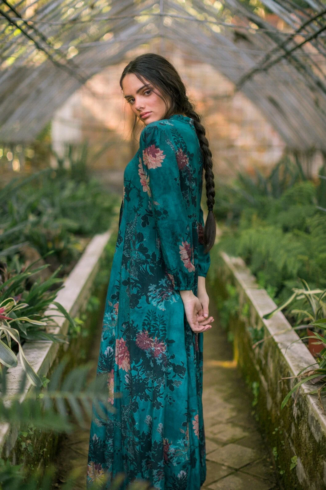 sideways-woman-posing-green-house-looking-camera_23-2148261256